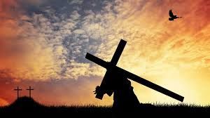 Jesus Holding Cross in Front of Sunset