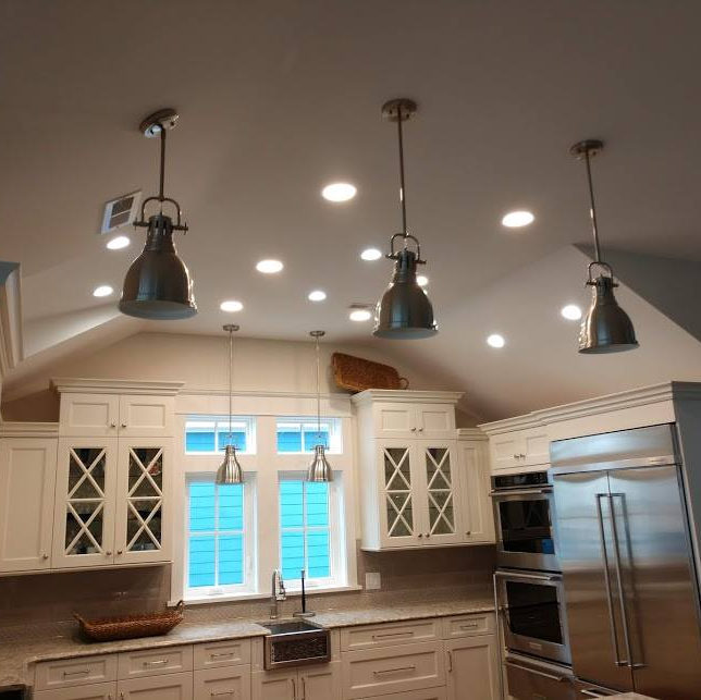 Kitchen with white cabinets, stainless steel appliances, and recessed lights by Shoreline Electric OBX