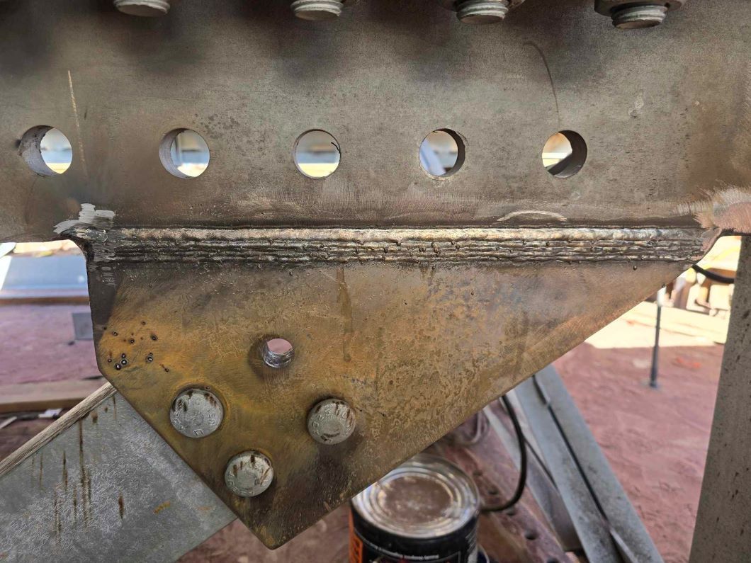 A close up of a metal structure with holes in it.