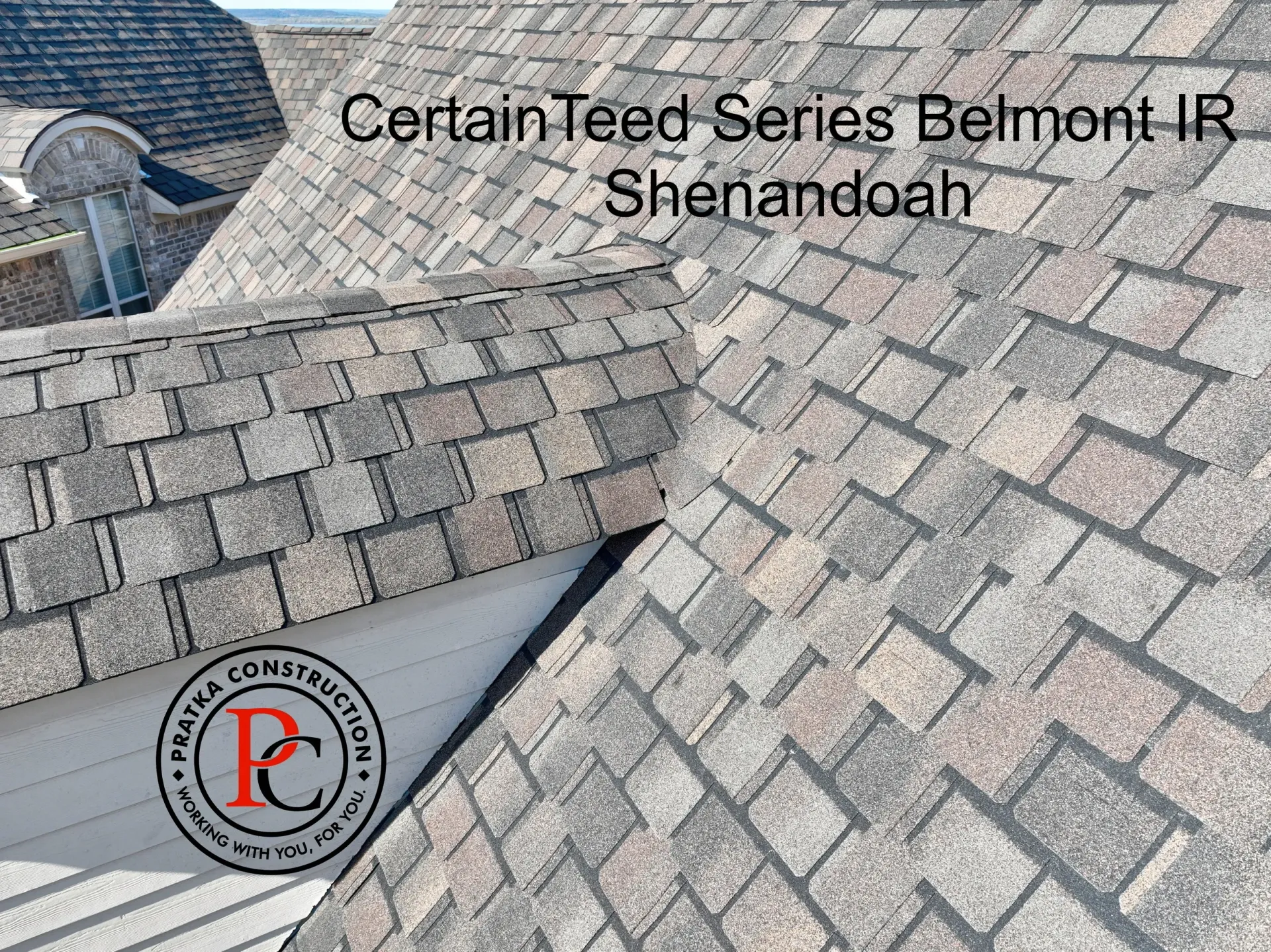 Close-up of a gray and brown CertainTeed Belmont IR Shenandoah shingle roof. Logo visible.