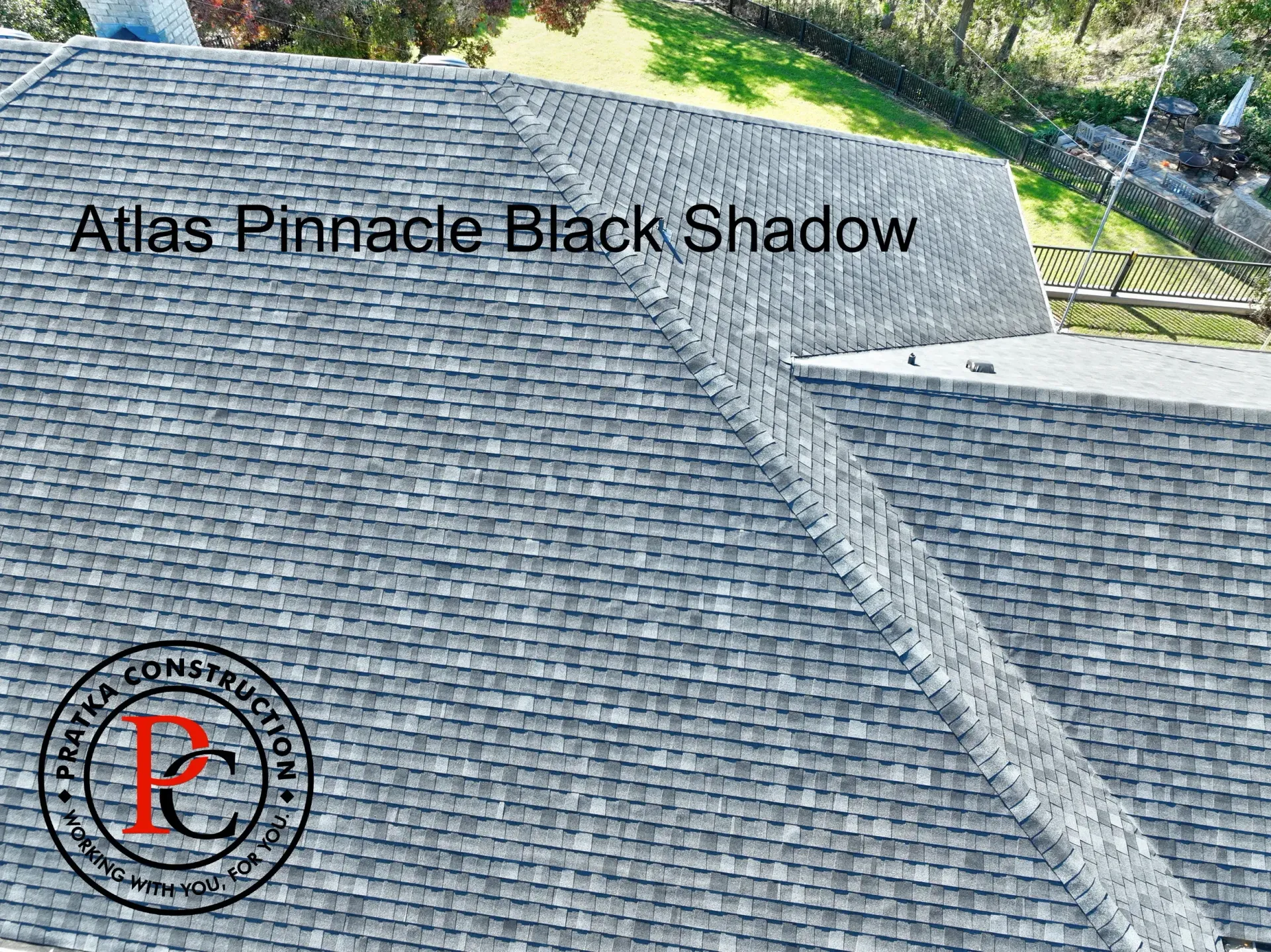 Overhead view of an Atlas Pinnacle Black Shadow shingle roof, with a company logo.