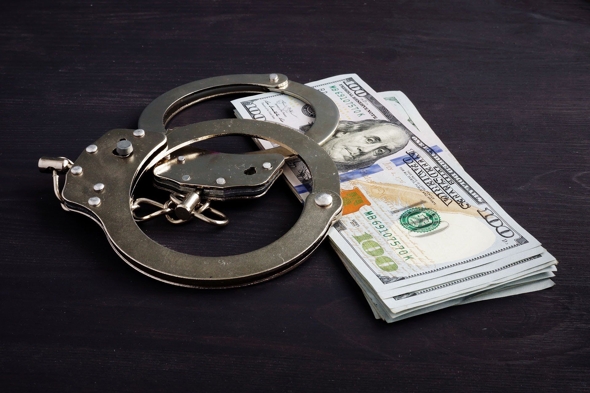 Handcuffs and Money — Charlotte, NC — A. Gray Bail Bonds, LLC