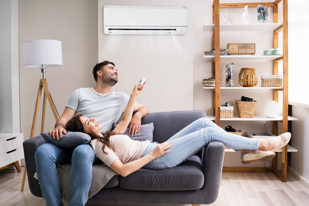 Couple Laying On Couch — Brod’s Refrigeration & Air Conditioning in Gilgandra, NSW