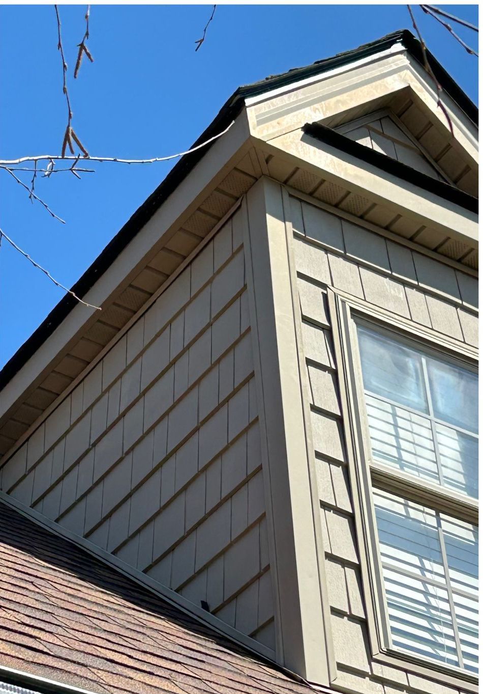 A house with a roof that has a window on it