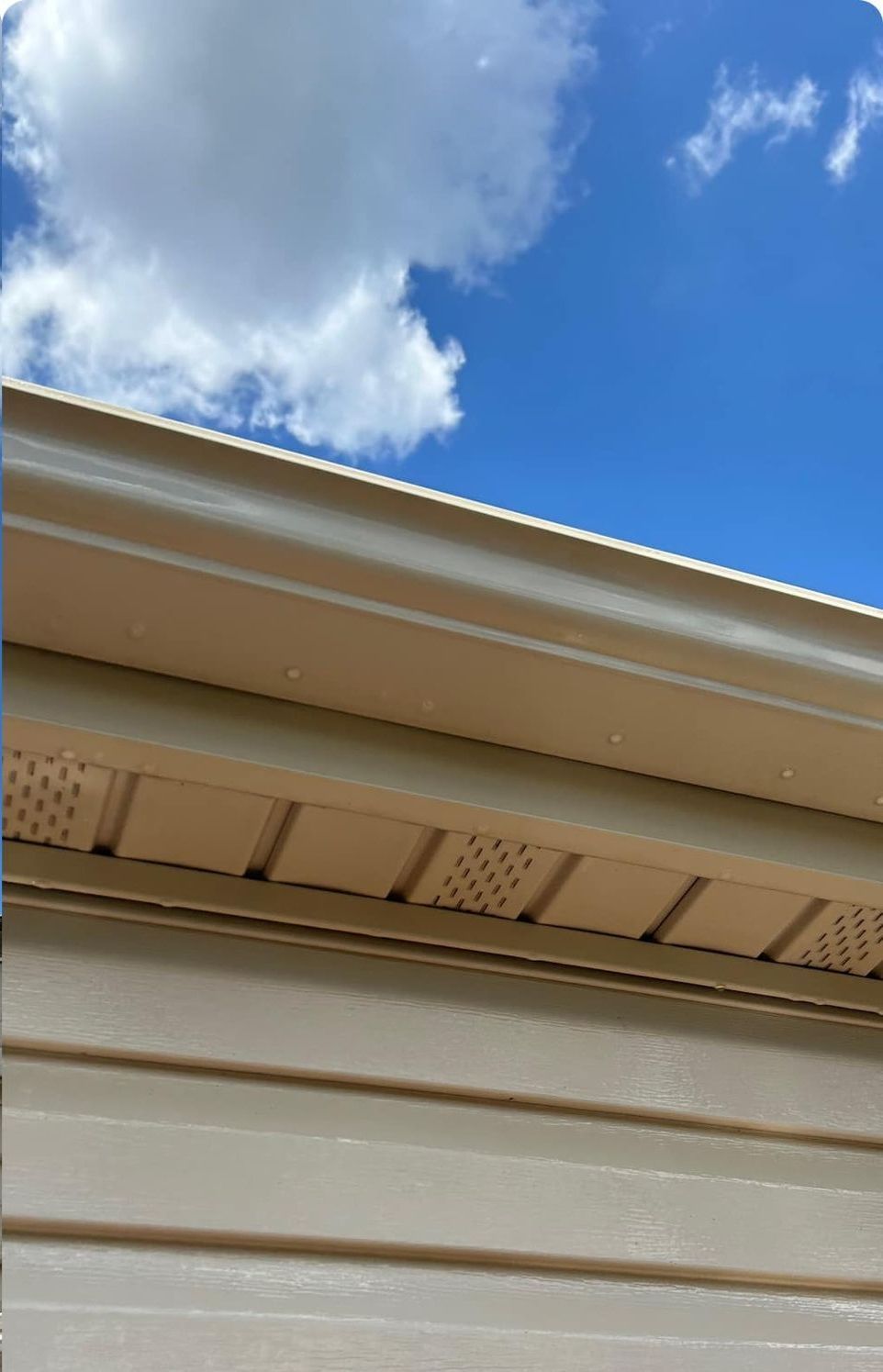 The roof of a house with a blue sky in the background