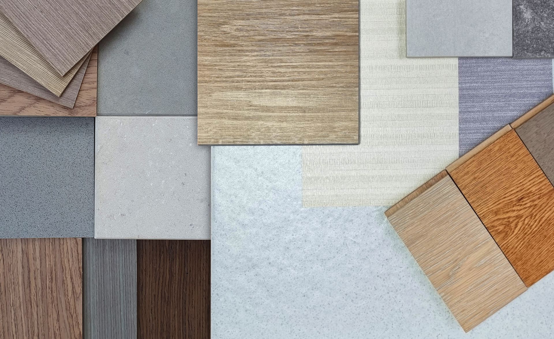 Samples of various flooring materials, including wood, stone, and carpet in neutral colors.