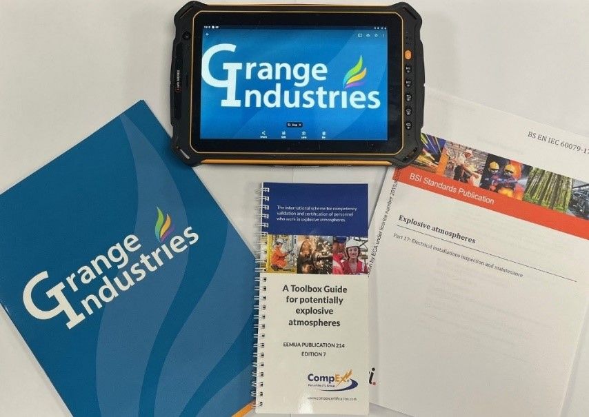 Orange Industries brochures, booklet, and a tablet displaying the Orange Industries logo on a white surface