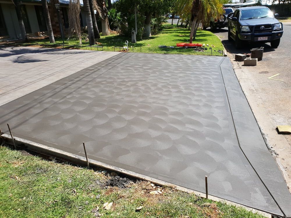 A Concrete Driveway Is Being Built In Front Of A House — Heartland Concrete In Gillen, NT
