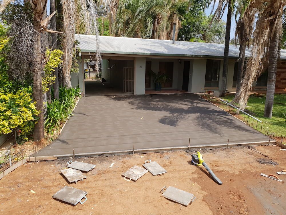 A Concrete Driveway Is Being Built In Front Of A House — Heartland Concrete In Gillen, NT