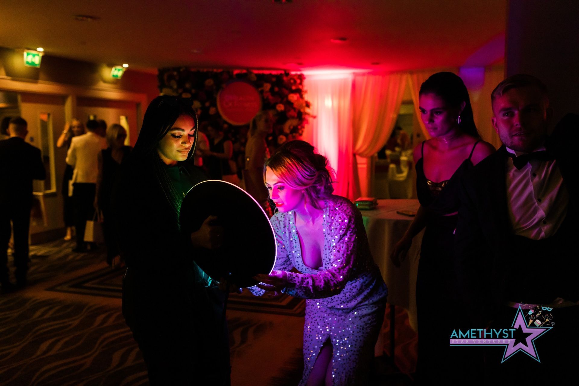 Guest interacting with an Amethyst Star Ventures roaming photo booth at an elegant Central Texas event