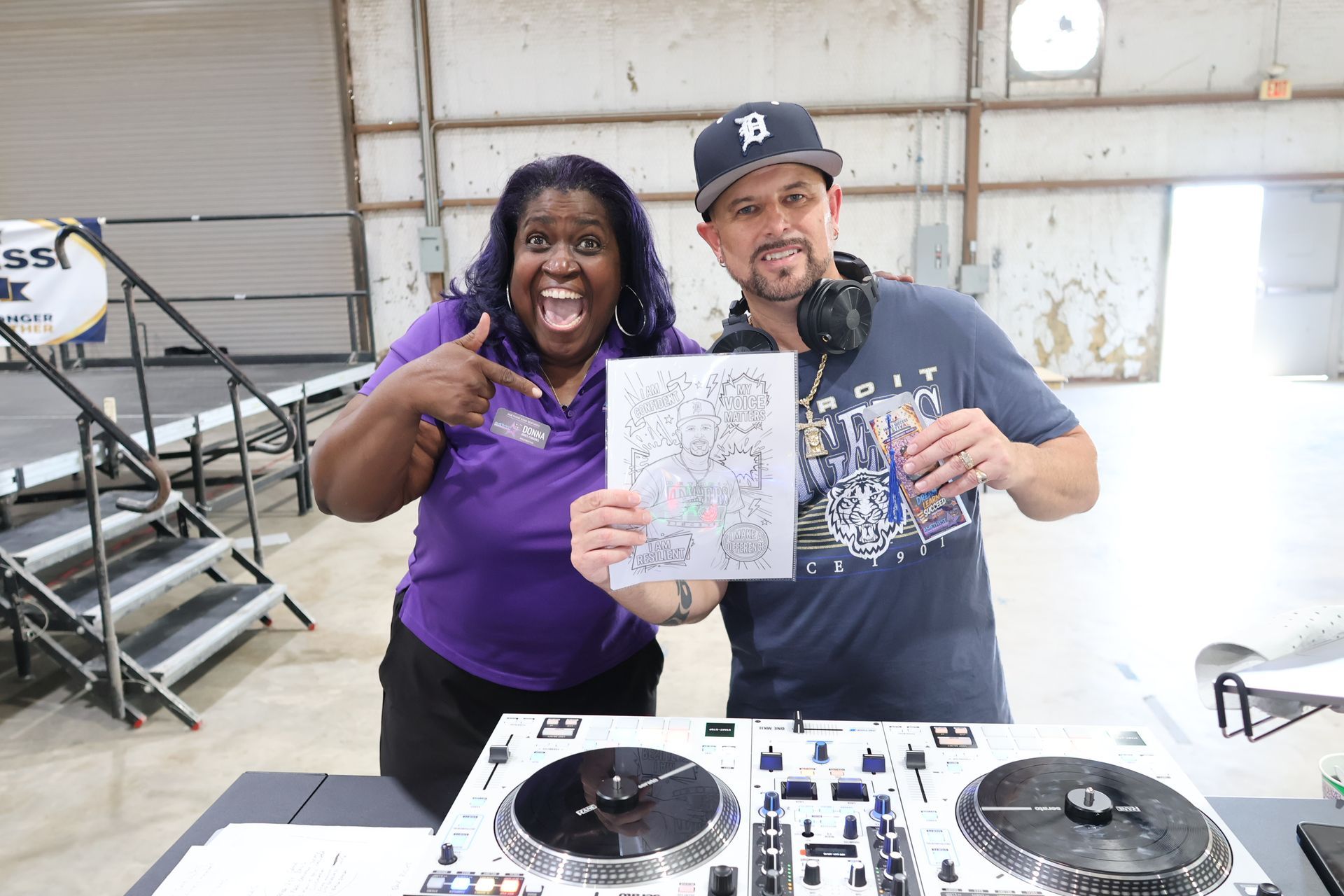 Donna presenting a personalized Color Me portrait and bookmark to an adult guest in Killeen