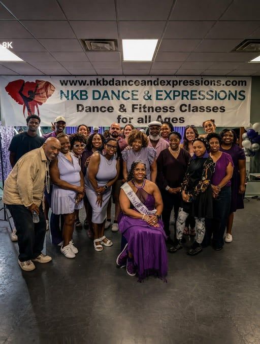 Dance and fitness class group posing indoors under an NKB Dance & Expression banner