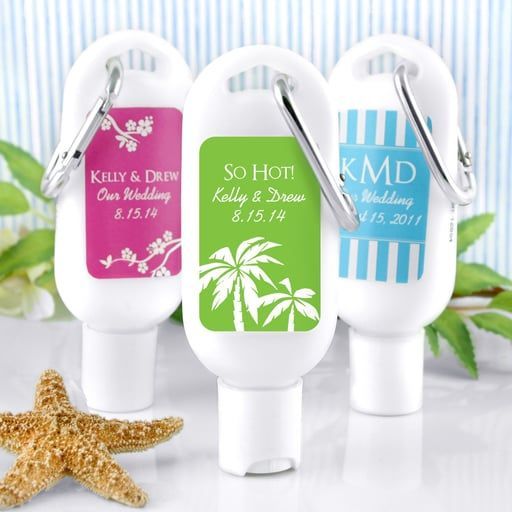 Three colorful sunscreen bottles with wedding labels, arranged with a starfish on a beach-themed background