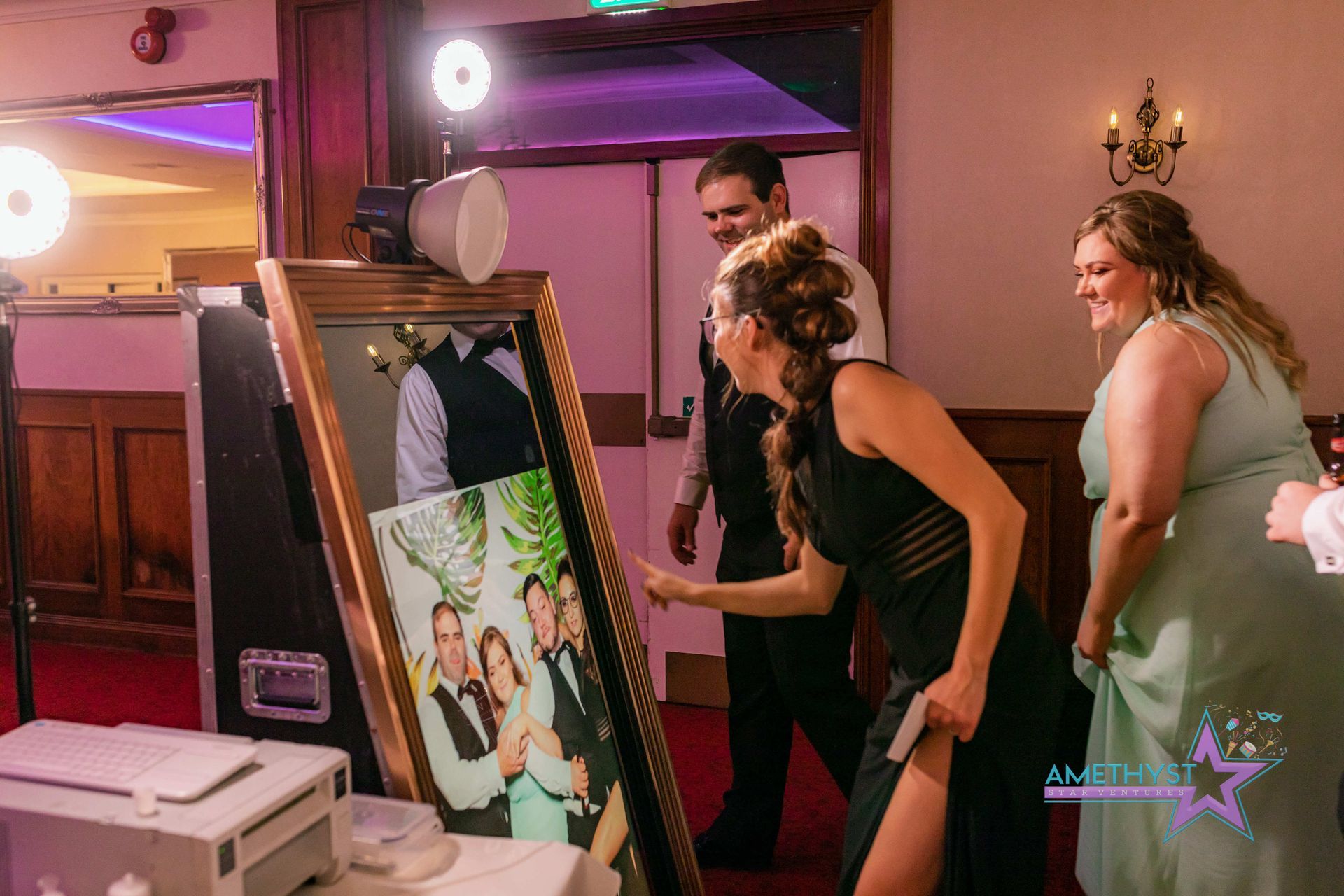 Guests enjoying a hosted Mirror photo experience with an Amethyst Star Ventures Event Ambassador