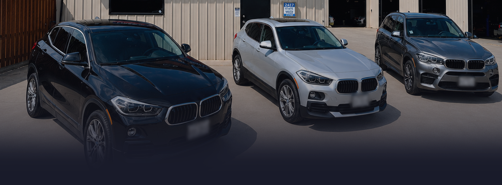 An automotive shop with three cars parked outside of our auto repair shop | Elite Automotive of Corpus Christi