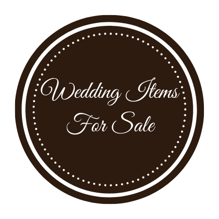Brown circular sign with white script reading “Wedding Items For Sale”