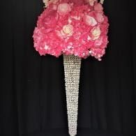 Pink floral cone-shaped bouquet on a black background