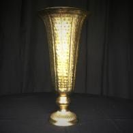 Gold decorative vase on a dark background