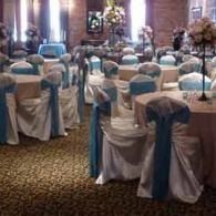 Banquet hall with round tables and chairs decorated in white and turquoise