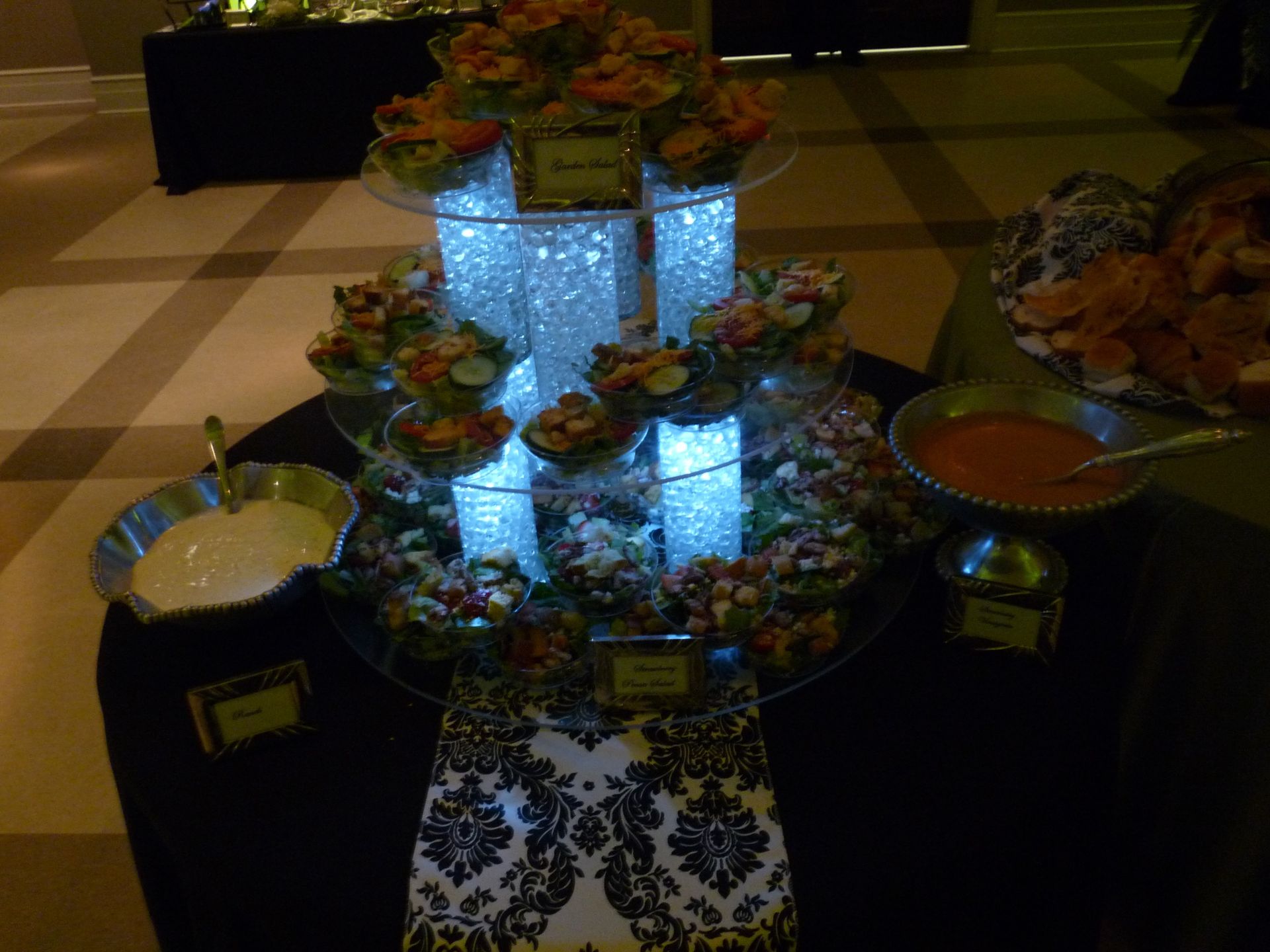 Floral centerpiece with glowing blue light on a decorated table at an indoor event