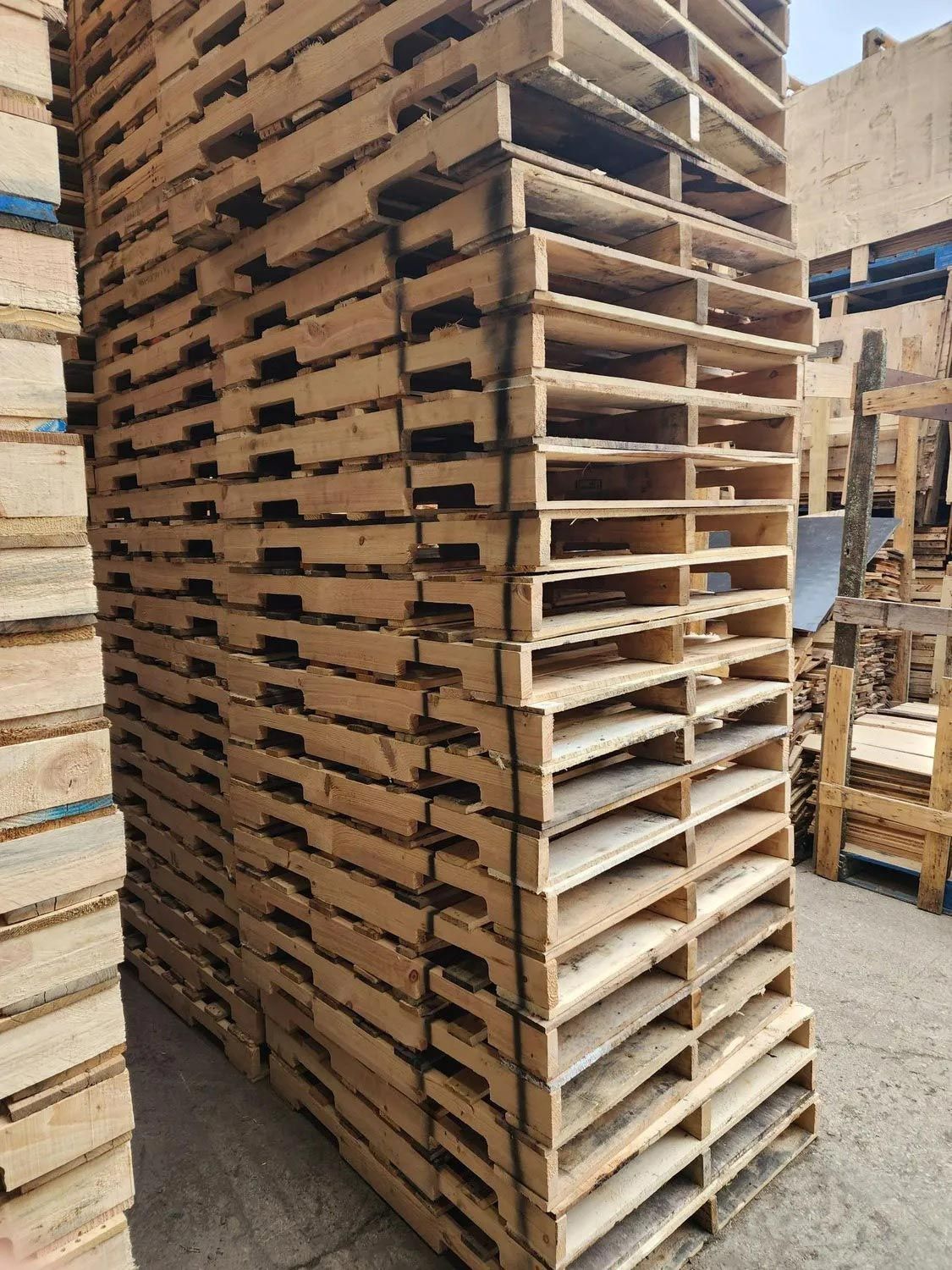 A pile of wooden pallets stacked on top of each other.