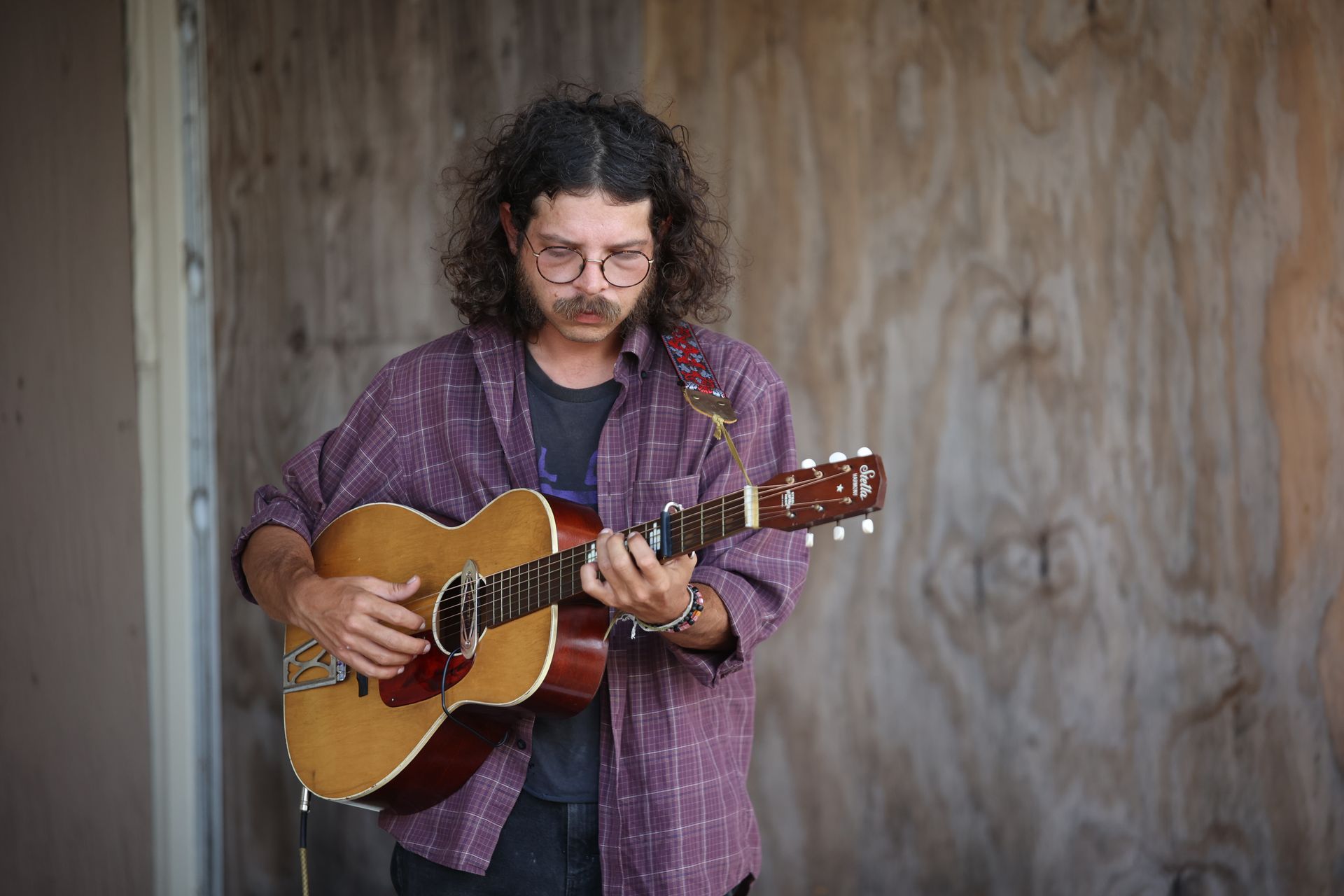 Man playing acoustic guitar in downtown Texarkana during Downtown LIVE