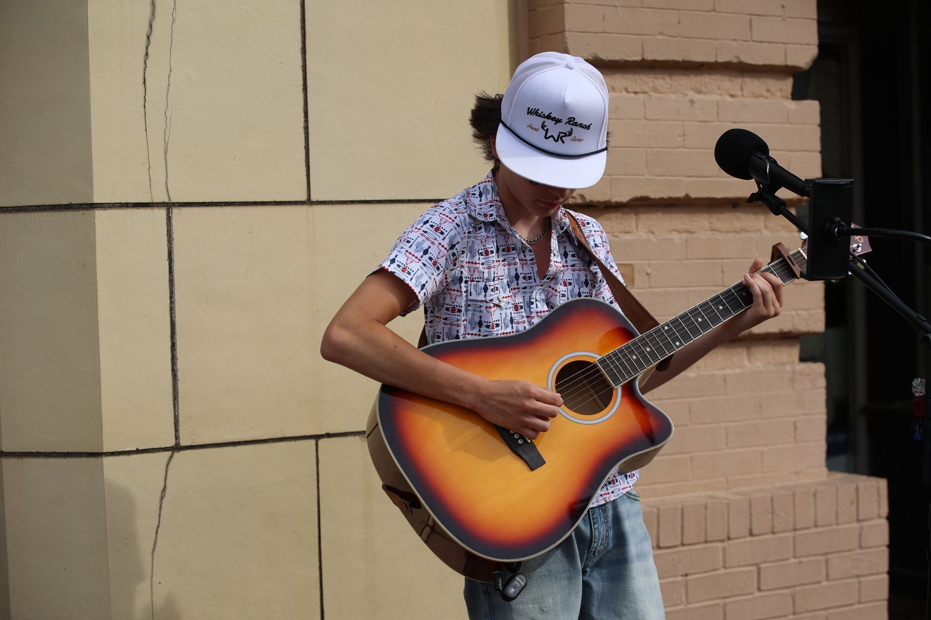 Street musician playing acoustic guitar in downtown Texarkana during Main Street Texarkana's Downtown LIVE