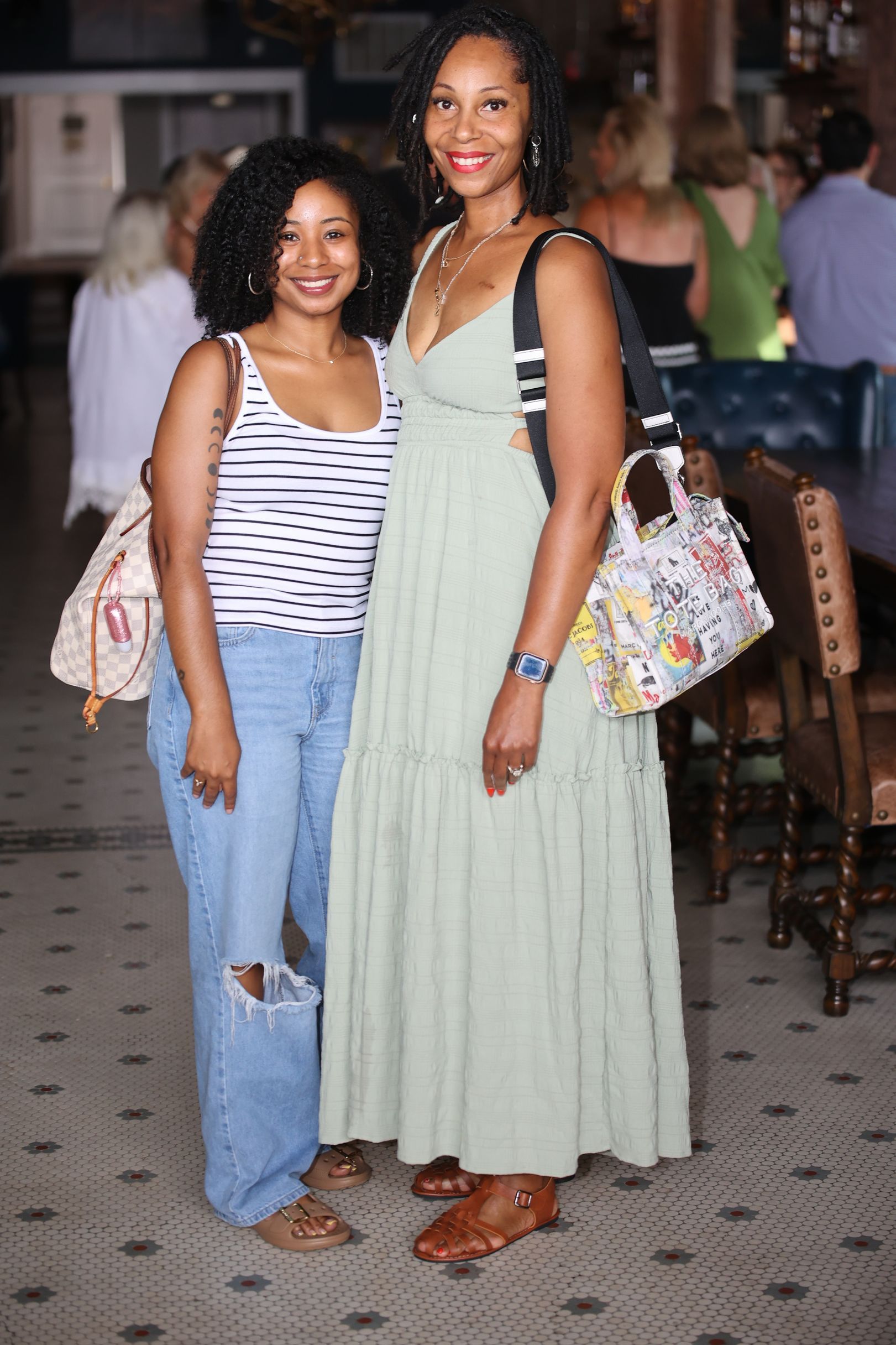 Two women standing together in a restaurant during Main Street Texarkana's Progressive Dinner