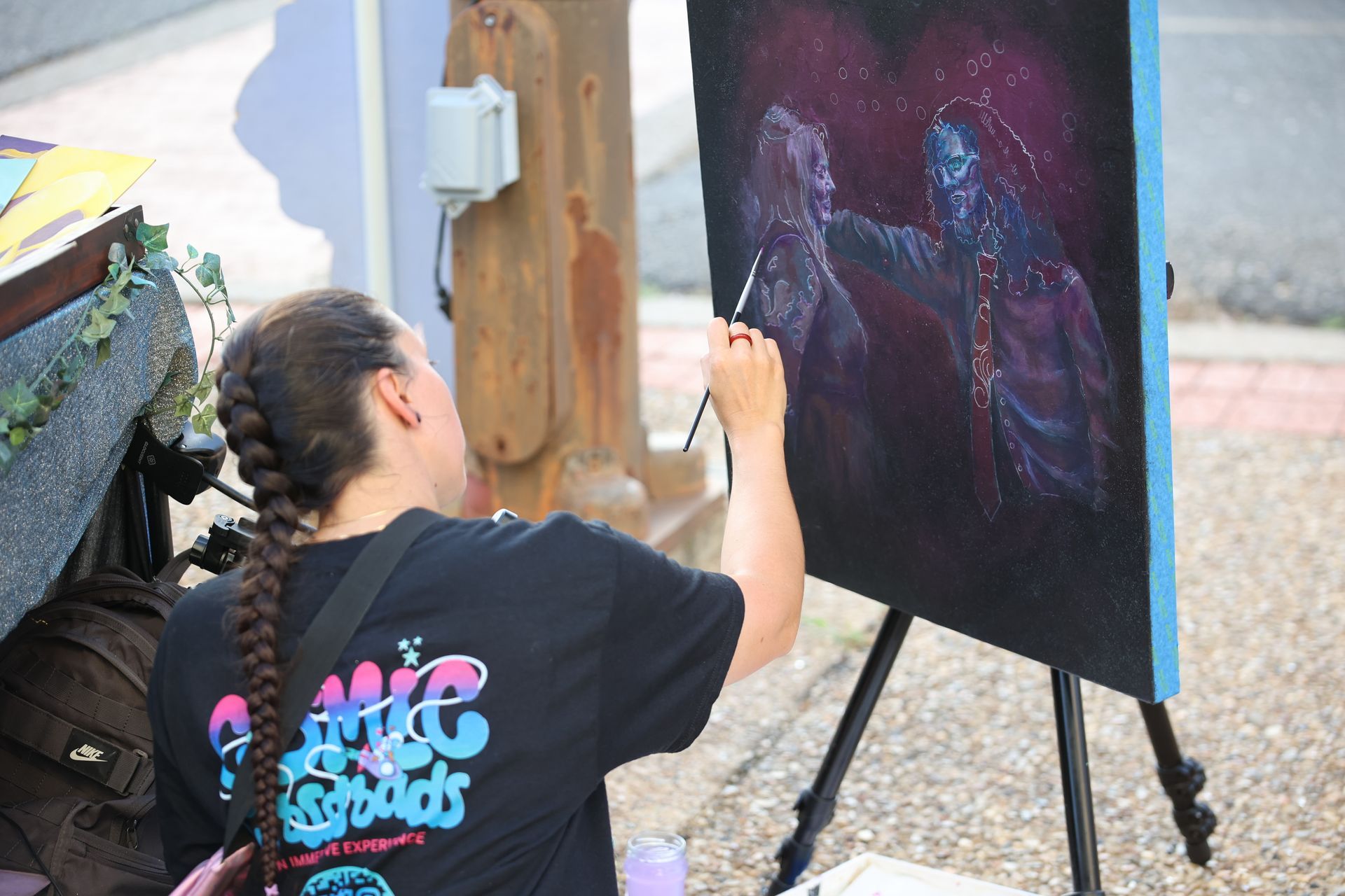 Person painting a colorful abstract artwork in Downtown Texarkana during Downtown LIVE