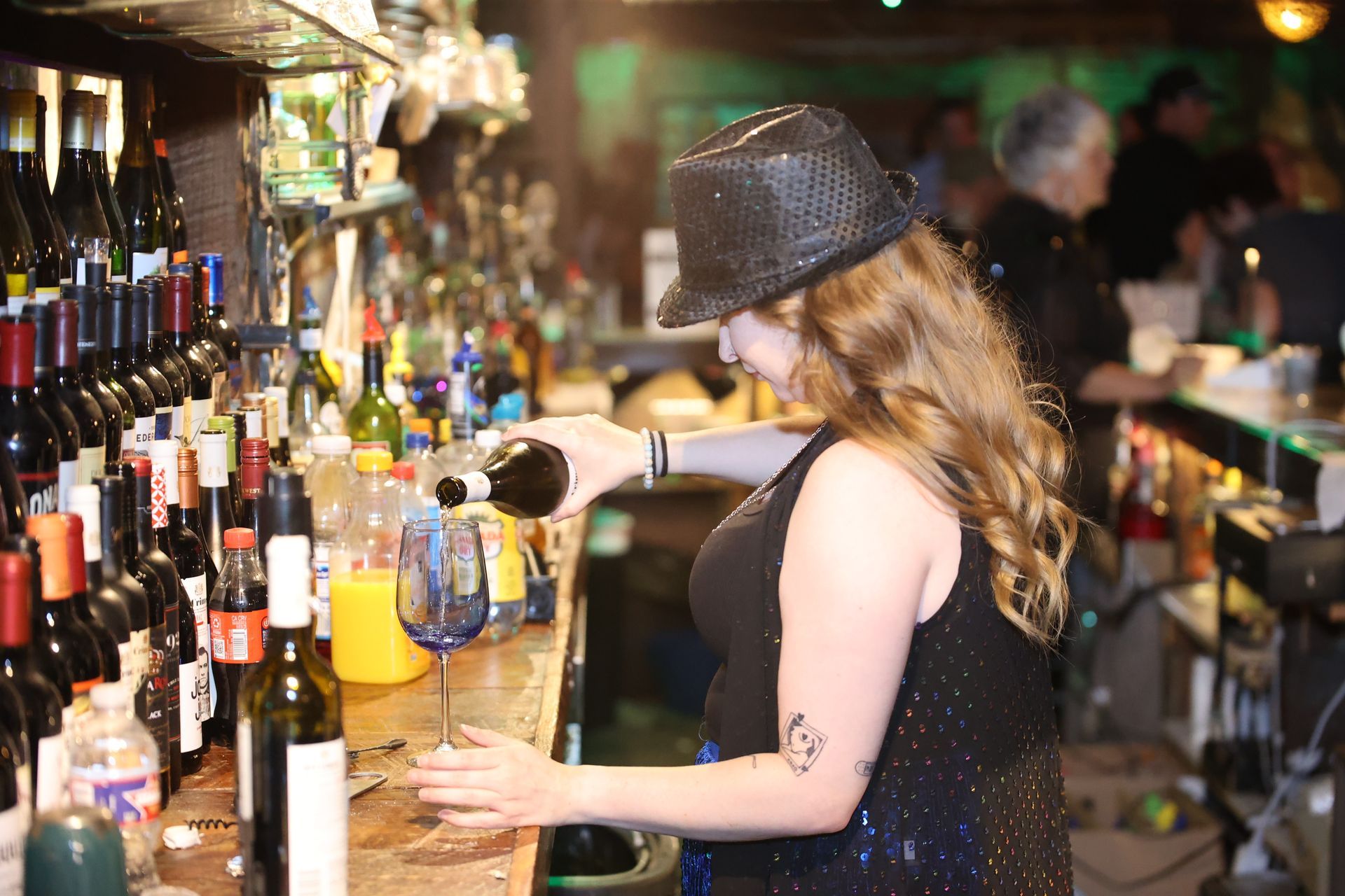 Bartender serving drinks at Banana Club in downtown Texarkana during Main Street Texarkana's Progressive Dinner