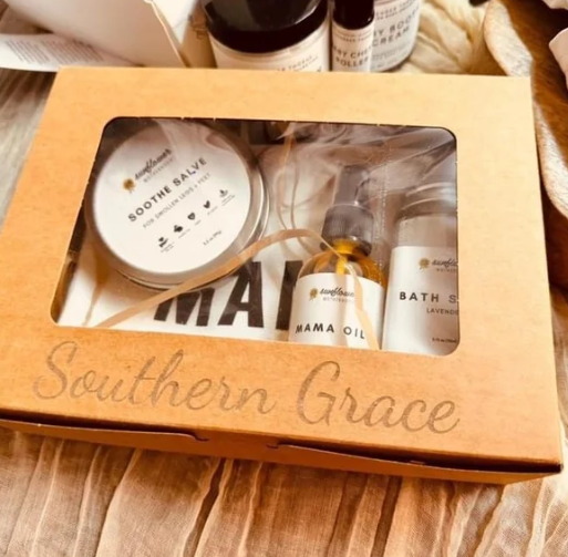 Gift box with Southern Grace inscription containing body care products; Soothe Salve, bath oil, bath soak.