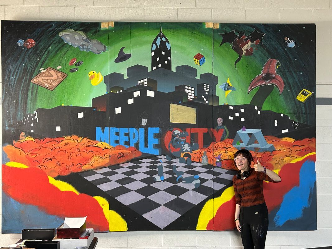 Person gives thumbs-up next to large mural titled 