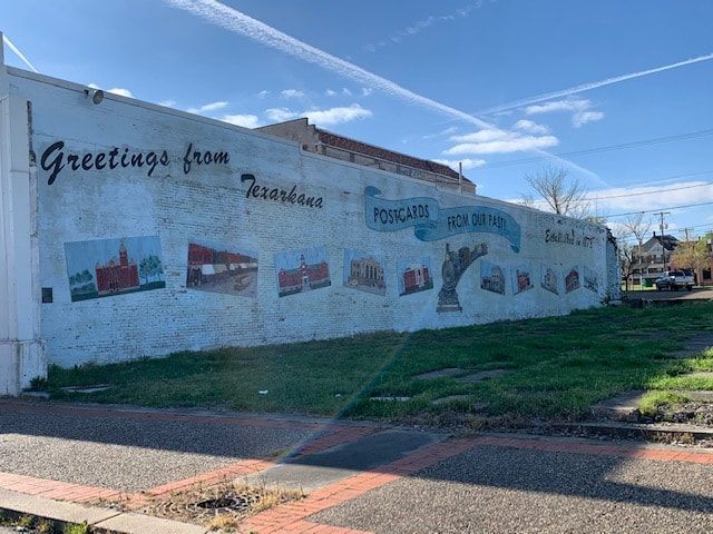 Mural on a wall reads
