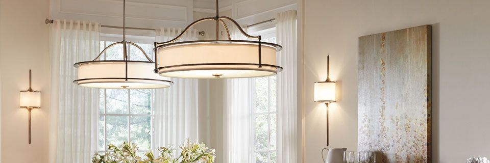 Dining room with pendant lights, sconces, and artwork on the wall.