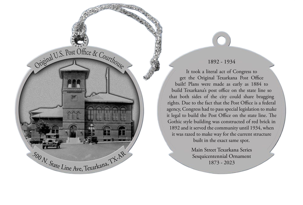 Silver ornament with a building on one side and text on the other. Rope attached for hanging.