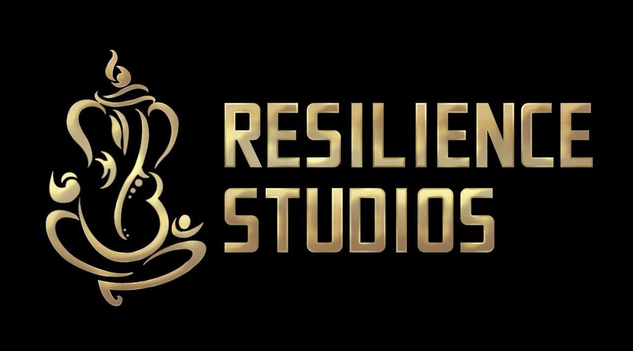 Golden logo: seated Ganesh figure next to