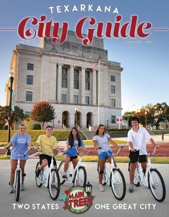 Texarkana City Guide cover. Five people on bikes in front of a courthouse. Red and blue text.