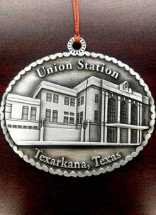 Ornament with a silver rendering of Texarkana, Texas' Union Station building.