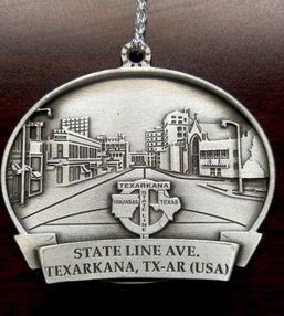 Ornament depicting State Line Ave. in Texarkana, TX-AR. Gray metal with buildings and street detail.