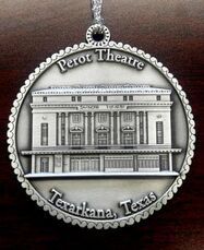 Ornament of the Perot Theatre in Texarkana, Texas. Silver, circular, detailed building facade.