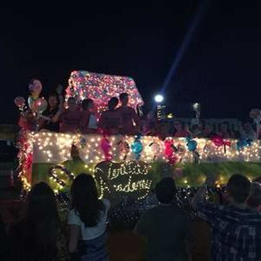 Float with lights and people, celebrating 