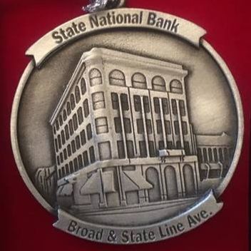 Medallion for State National Bank, featuring a building illustration and