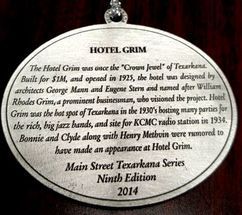 Oval plaque with text about the Hotel Grim in Texarkana, built in 1925.