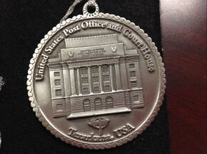 Silver coin with a detailed depiction of the United States Post Office and Courthouse in Terre Haute, USA.