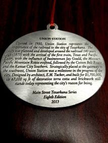 Oval ornament with text about Texarkana Union Station: history, architect, and building cost;