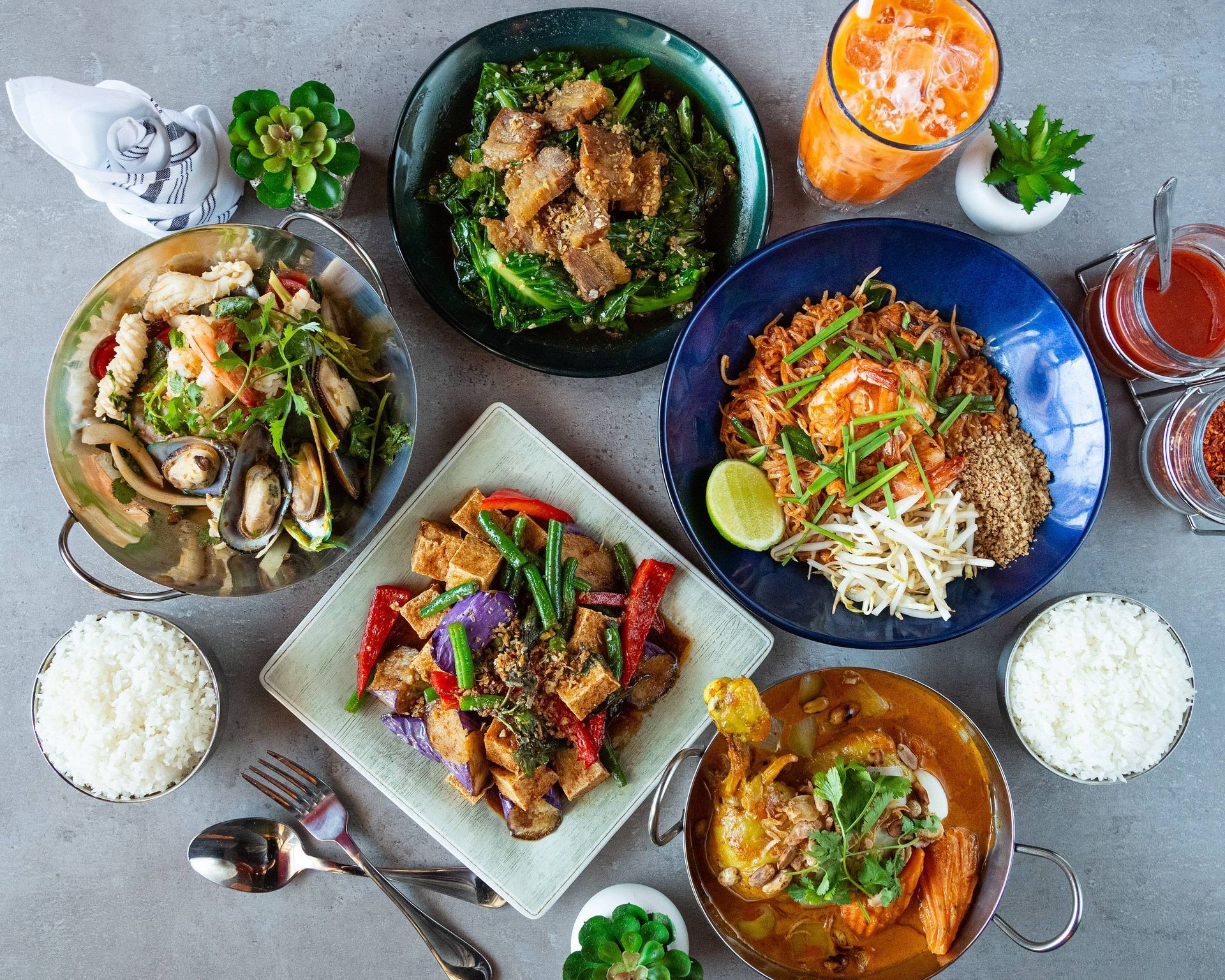 A table topped with plates of food and drinks.