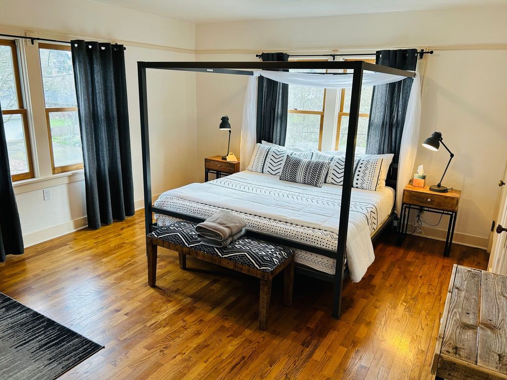 There is a four poster bed in the middle of the room.