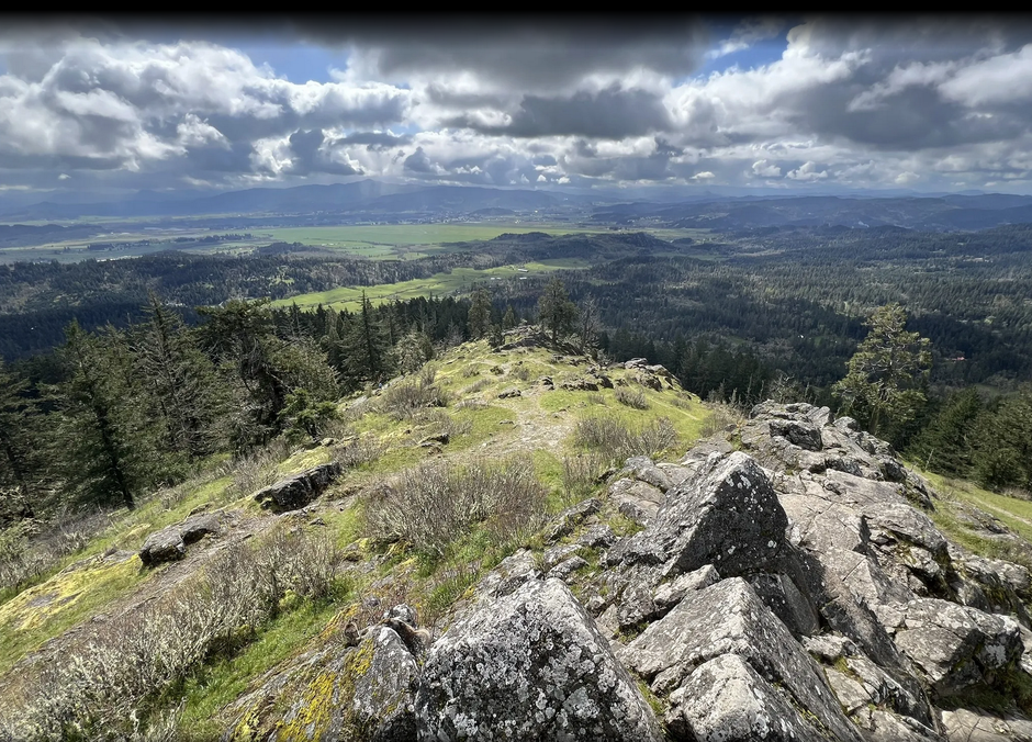 A view of a valley from the top of a mountain.