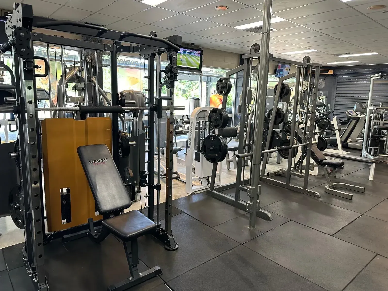 A Gym Filled With Lots Of Exercise Equipment And A Television — Maxenergy Fitness In Smithfield, QLD