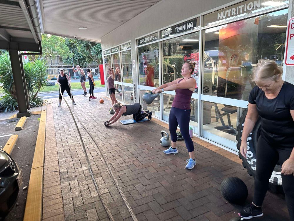 A Group of People Are Exercises With Equipment outside — Maxenergy Fitness in Smithfield, QLD
